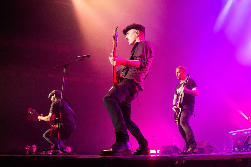 Kaspar Boye Larsen, bassist of the danish heavy metal band Volbeat, at Rockhal in Luxembourg during their "Rewind, Replay, Rebound" tour in 2019, with Michael Poulsen and Rob Caggiano